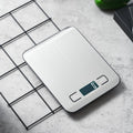 Vertex Kitchenware digital kitchen scale with a slim, compact design, featuring a clear digital display and stainless steel weighing surface.