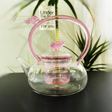 Colorful hand-painted butterfly design on Vertex Kitchenware borosilicate teapot for tea or coffee brewing.